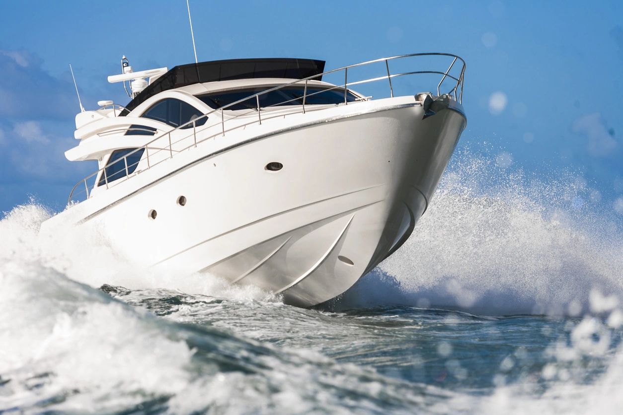 White motor yacht in ocean spray